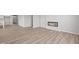 Open-concept living area includes wood-look flooring and an electric fireplace feature at 5040 Carmine St, Brownsburg, IN 46112