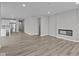Open-concept living area with a modern fireplace and seamless flow to the kitchen at 5040 Carmine St, Brownsburg, IN 46112