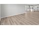 Spacious living room with wood-look floors, neutral walls, and an open layout at 5040 Carmine St, Brownsburg, IN 46112