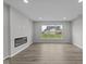 Spacious living area featuring a modern fireplace and a large window with backyard view at 5040 Carmine St, Brownsburg, IN 46112