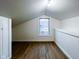 Finished attic space with wood floors, neutral walls and a window at 5103 E St Clair St, Indianapolis, IN 46219