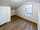 Finished attic with hardwood floors, neutral walls, and plenty of natural light at 5103 E St Clair St, Indianapolis, IN 46219