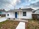 Attractive white one-story home with a tidy front yard and classic architectural details at 5103 E St Clair St, Indianapolis, IN 46219