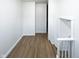 Hallway with wood floors and freshly painted white walls at 5103 E St Clair St, Indianapolis, IN 46219