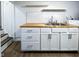 Kitchen features white cabinets with stainless pulls, butcher block counters, and stainless steel sink at 5103 E St Clair St, Indianapolis, IN 46219