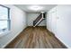 Spacious living room boasting hardwood floors, fresh paint, and large windows at 5103 E St Clair St, Indianapolis, IN 46219