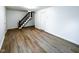 Open living room featuring hardwood floors and a staircase at 5103 E St Clair St, Indianapolis, IN 46219