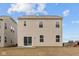 The back of a neutral-colored two-story home with sliding glass doors and a compact yard space at 5119 Rolling Meadow Blvd, Indianapolis, IN 46237