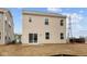 The back of a two-story home with sliding glass doors leading to a flat, unfinished backyard at 5119 Rolling Meadow Blvd, Indianapolis, IN 46237