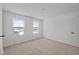 Bright bedroom featuring neutral carpet, two windows, and white walls at 5119 Rolling Meadow Blvd, Indianapolis, IN 46237