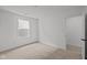 Bright bedroom featuring neutral carpet, a window, and white walls at 5119 Rolling Meadow Blvd, Indianapolis, IN 46237