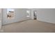 A bright bedroom features neutral carpeting, large windows, and an ensuite bathroom at 5119 Rolling Meadow Blvd, Indianapolis, IN 46237