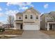 Inviting two-story home with attached garage, featuring a classic facade and well-manicured driveway at 5119 Rolling Meadow Blvd, Indianapolis, IN 46237