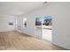 Bright living room featuring wood-look flooring, a fireplace, large windows and glass sliding doors to the backyard at 5119 Rolling Meadow Blvd, Indianapolis, IN 46237
