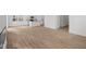 Open floorplan features modern wood floors and a bright living room leading to the kitchen at 5119 Rolling Meadow Blvd, Indianapolis, IN 46237