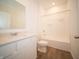 Clean bathroom featuring a vanity with quartz countertops and a shower-tub combo at 5146 Cartland Dr, Indianapolis, IN 46239