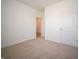 Cozy bedroom with neutral carpet, white walls, and a view towards another room at 5146 Cartland Dr, Indianapolis, IN 46239