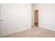 Well-lit bedroom with neutral carpet, white walls, and a view into the hallway at 5146 Cartland Dr, Indianapolis, IN 46239