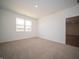 Vacant bedroom showing carpeting, neutral walls, and a window at 5146 Cartland Dr, Indianapolis, IN 46239