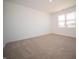 A vacant bedroom with neutral carpet, one window, and light-colored walls at 5146 Cartland Dr, Indianapolis, IN 46239