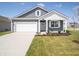 Charming home featuring a well-maintained lawn, gray siding, and a spacious two-car garage at 5146 Cartland Dr, Indianapolis, IN 46239