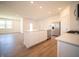 Bright, open kitchen with island, stainless steel appliances, and wood-style flooring at 5146 Cartland Dr, Indianapolis, IN 46239