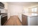 This modern kitchen features stainless steel appliances, white cabinetry, and an island with a sink at 5146 Cartland Dr, Indianapolis, IN 46239