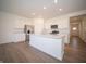 Modern kitchen with a large island, stainless steel appliances, and ample cabinet space at 5146 Cartland Dr, Indianapolis, IN 46239