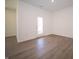 Bright room with new flooring, fresh paint, and a door leading to the backyard at 5146 Cartland Dr, Indianapolis, IN 46239