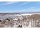A panoramic aerial view captures the home's picturesque location near the waterfront, with a bridge and icy lake view at 6842 Cardinal Dr, McCordsville, IN 46055