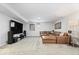 Finished basement featuring a large brown sectional, big-screen TV, and plush carpeting at 6842 Cardinal Dr, McCordsville, IN 46055