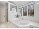Bright bathroom with a soaking tub, walk-in shower, and large window view at 6842 Cardinal Dr, McCordsville, IN 46055
