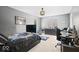 Bedroom features dark furniture, a desk setup, and natural light coming through the large window at 6842 Cardinal Dr, McCordsville, IN 46055