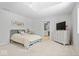 Bedroom featuring neutral tones, a tray ceiling, and an ensuite bathroom at 6842 Cardinal Dr, McCordsville, IN 46055