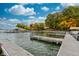 View of boat docks and waterfront property surrounded by lush trees under a cloudy blue sky at 6842 Cardinal Dr, McCordsville, IN 46055