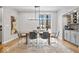 The light-filled dining room boasts modern furnishings, hardwood floors, and a bar area for entertaining at 6842 Cardinal Dr, McCordsville, IN 46055
