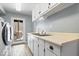Convenient laundry room area with modern washer and dryer and utility sink at 6842 Cardinal Dr, McCordsville, IN 46055