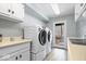 Well-lit laundry room with modern washer and dryer units and utility sink at 6842 Cardinal Dr, McCordsville, IN 46055