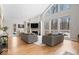 Well lit living room with fireplace, hardwood floors and large windows at 6842 Cardinal Dr, McCordsville, IN 46055