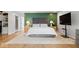 Stylish main bedroom featuring hardwood floors, accent wall, and an ensuite closet at 6842 Cardinal Dr, McCordsville, IN 46055