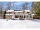 Expansive rear exterior featuring a large deck, a sunroom, and a spacious backyard blanketed in fresh, powdery snow at 6842 Cardinal Dr, McCordsville, IN 46055