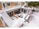 A beautiful covered patio offers ample seating, a fire pit, and access to a sunroom, surrounded by fresh snow at 6842 Cardinal Dr, McCordsville, IN 46055