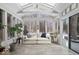 Bright sunroom featuring hardwood-look floors, lots of windows, a ceiling fan, and modern furnishings at 6842 Cardinal Dr, McCordsville, IN 46055