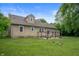 Grassy backyard featuring a cozy patio with a charming outdoor dining set perfect for entertaining at 6865 Meadow View Dr, Lawrence, IN 46226