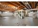 Unfinished basement with exposed ceiling, string lights, and concrete floor at 6865 Meadow View Dr, Lawrence, IN 46226