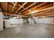 Unfinished basement with a staircase, exposed beams, and concrete flooring at 6865 Meadow View Dr, Lawrence, IN 46226