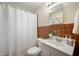 Compact bathroom with retro tile, a shower curtain, and a simple vanity at 6865 Meadow View Dr, Lawrence, IN 46226