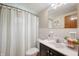 Tidy bathroom with white tile, a decorative shower curtain, and neutral wall color at 6865 Meadow View Dr, Lawrence, IN 46226