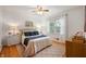 Cozy bedroom with a ceiling fan, plush rug, and soft natural light through the window at 6865 Meadow View Dr, Lawrence, IN 46226