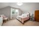 Comfortable bedroom with natural light, neutral walls and a cozy chair at 6865 Meadow View Dr, Lawrence, IN 46226
